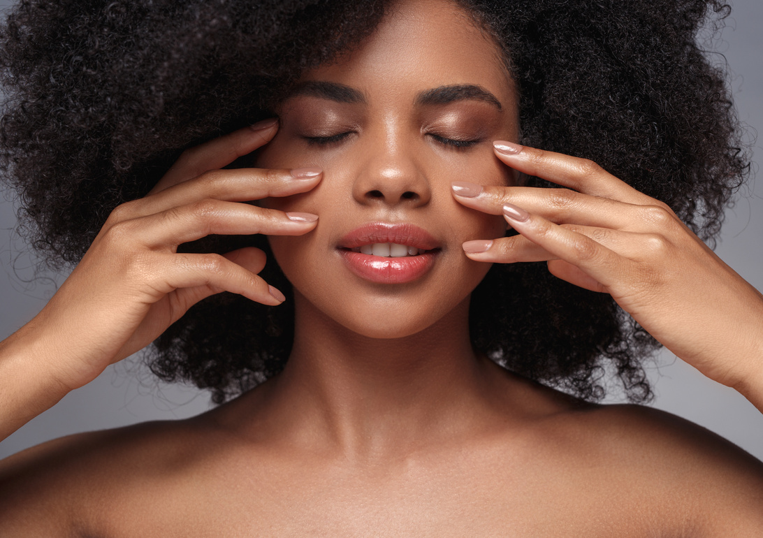 Beautiful black model touching perfect clean skin